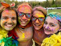 Girls covered in colorful dust
